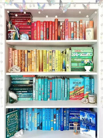 treatyoshelves17 Instagram post about Pride Month bookshelf